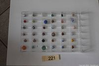 Clear tray showing 36 marbles arranged in rows