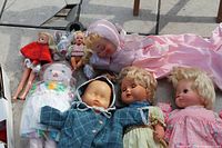 Group shot of all dolls and plush laid out