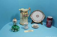 Full lot overview showing plate, pitcher, bud vase, perfume bottle base, miniature cup and saucer