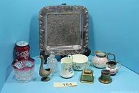 Group shot showing all items including tray, inkwells, bowl, porcelain pieces, goose figurine and cut glass bottle