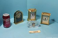 Group shot of five quartz clocks with scale reference