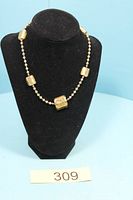 Full view of necklace on display bust showing square glass beads and round spacers