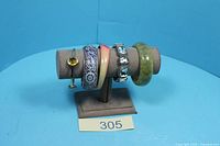 All five bracelets displayed on stand