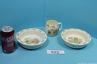 Group image of two Bunnykins bowls and one cup with size reference