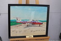 Front view of framed signed Snowbirds picture on easel