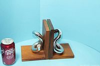 pair of bookends next to soda can for scale