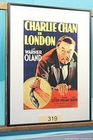 Framed Charlie Chan in London movie poster with visible cast names and frame detail