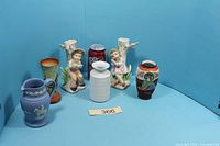 Group shot of all six items including pitcher, three vases, two figurines with reference can