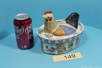 Tureen with soda can for scale, hen lid in place