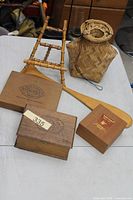 Group shot showing all items: three cigar boxes, bamboo easel, paddle, basket