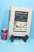 Front of book beside soda can for scale