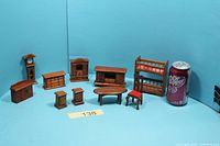 All eight wooden dollhouse furniture pieces with soda can for scale