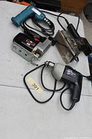 Overview of four power tools on table