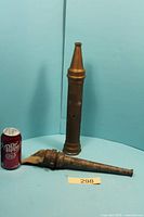 Two nozzles beside soda can for scale