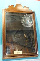 Front view of rectangular wooden framed mirror with scrolled top