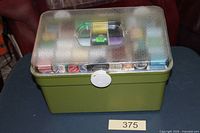 closed green sewing box with clear lid