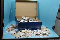 shoe box filled with loose world stamps