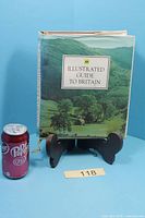 Front view of AA Illustrated Guide to Britain hardcover book on stand with scale reference