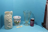 Group shot of vase, planter, pitcher with soda can for scale