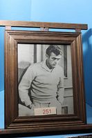 Framed black and white portrait print of James Dean in wooden frame