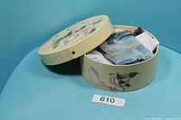 Open box displaying contents of mixed scarves