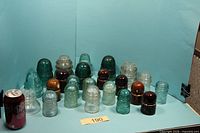 Full group shot of 23 insulators with reference can for scale