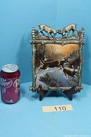 Front view showing full plate design and scale can