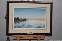 Framed print showing lighthouse scene, full view with frame and mat