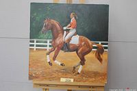 Full view of the oil painting on easel showing rider on horse