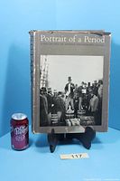 Front view of book with dust jacket beside soda can for scale