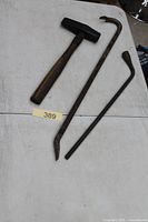 hammer, pry bar and lug bar laid on table