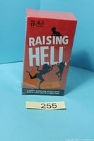 Front view of sealed Raising Hell game box