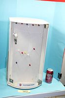 Front view of Victorinox rotating display case next to soda can for scale