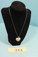 Pendant necklace displayed on stand with lot number visible