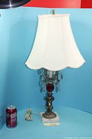 Full view of lamp with shade beside soda can for scale