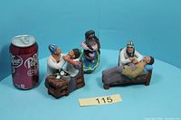 All three figurines with soda can for scale