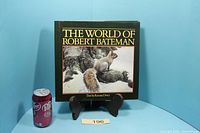 Front cover of hardcover art book next to soda can for scale