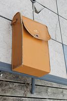 Brown vinyl carrying case hanging on table edge