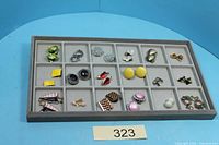 Tray with 18 pairs of assorted clip-on earrings