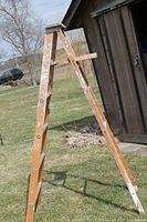 Full side view of 6-ft wooden step ladder outdoors