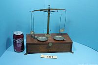 Front view of balance scale next to soda can for size reference