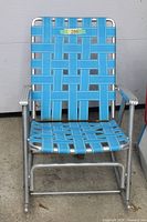 Front view of blue webbing aluminum rocking chair
