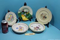 Overall lot with five dishes on display