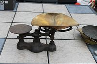 Full view of Detecto cast iron counter scale with brass scoop pan and round platform