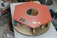 Top view of hexagonal-roof round dollhouse showing overall form