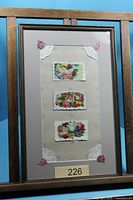 Full view of framed calling cards in wooden frame
