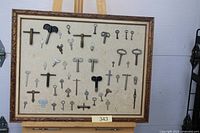 Full view of framed key display on easel