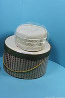 Hat resting on hat box showing full lot