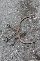 Full view of iron ice tongs on ground