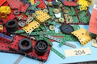 Pile of Meccano strips, plates, pulleys, wheels and motor